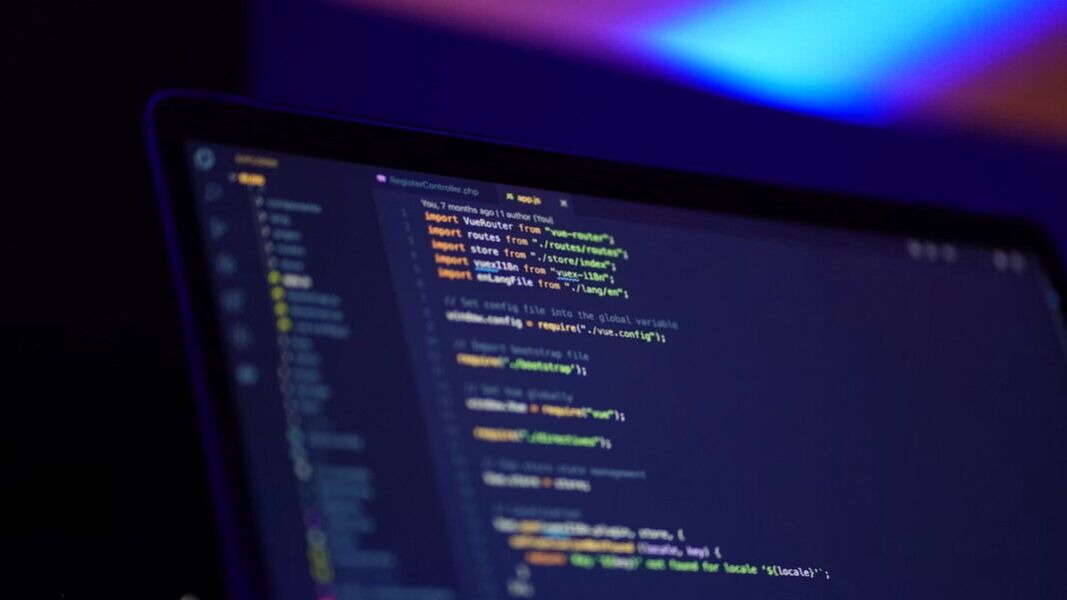 aptop screen displaying colorful code coding source code